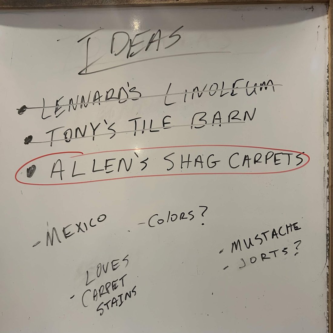 A whiteboard of brand-name ideas, two crossed out, with &lsquo;Allen&rsquo;s Shag Carpets&rsquo; circled
